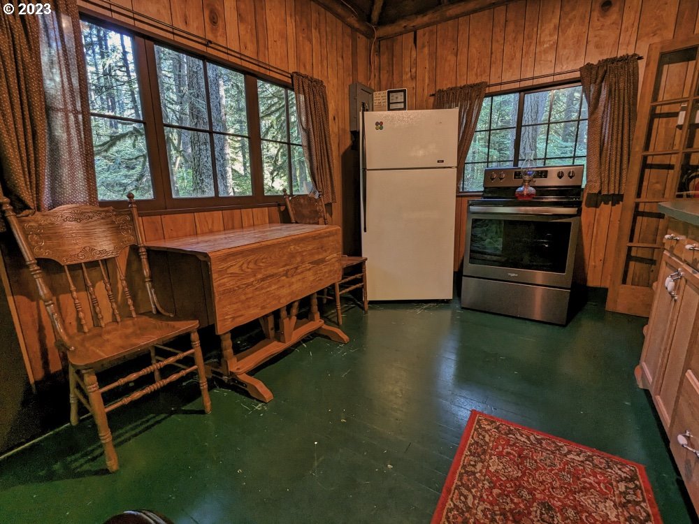 79128 Road 35 A Rhododendron, OR 97049 - Photo 17 of 36 a kitchen with a table chairs and a refrigerator