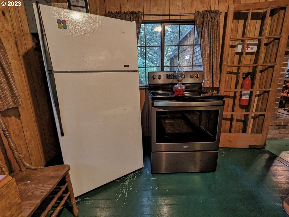 79128 Road 35 A Rhododendron, OR 97049 - Photo 18 of 36 a white refrigerator freezer and a stove sitting inside of a kitchen