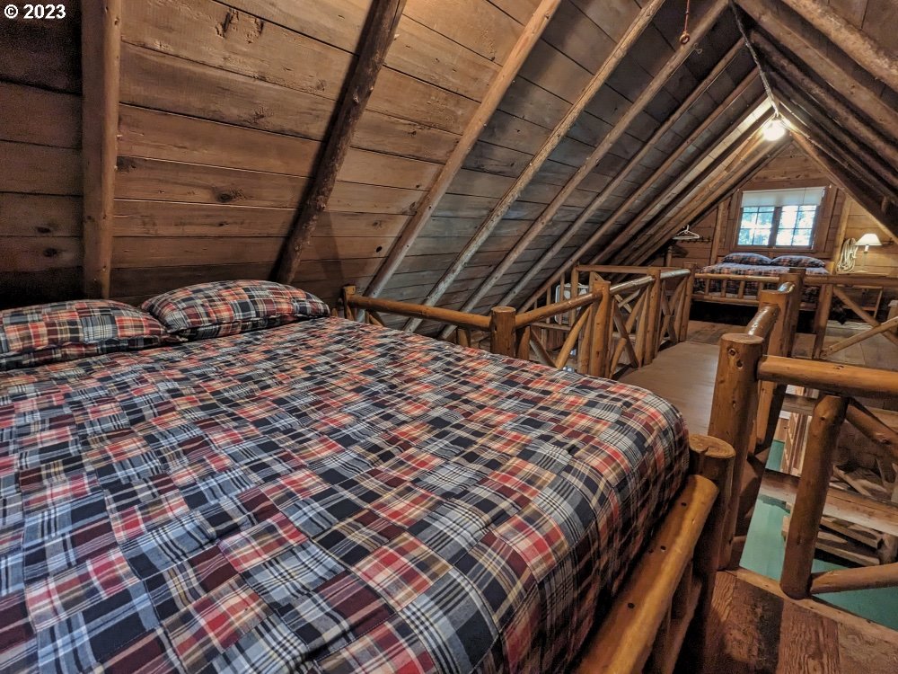 79128 Road 35 A Rhododendron, OR 97049 - Photo 26 of 36 a bed sitting in a bedroom next to a window