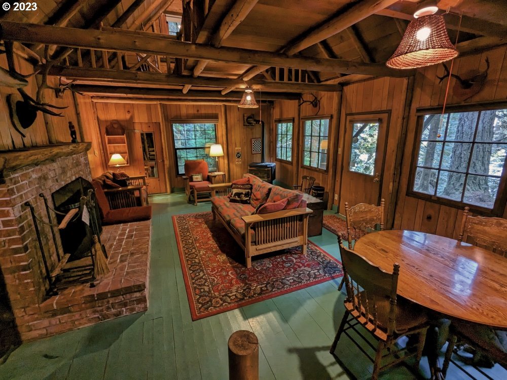 79128 Road 35 A Rhododendron, OR 97049 - Photo 4 of 36 a living room with furniture a fireplace and a table