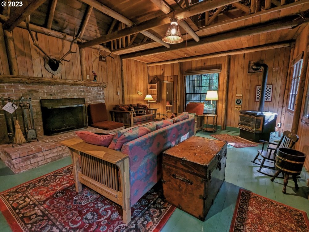 79128 Road 35 A Rhododendron, OR 97049 - Photo 7 of 36 a living room with furniture a rug and a fireplace