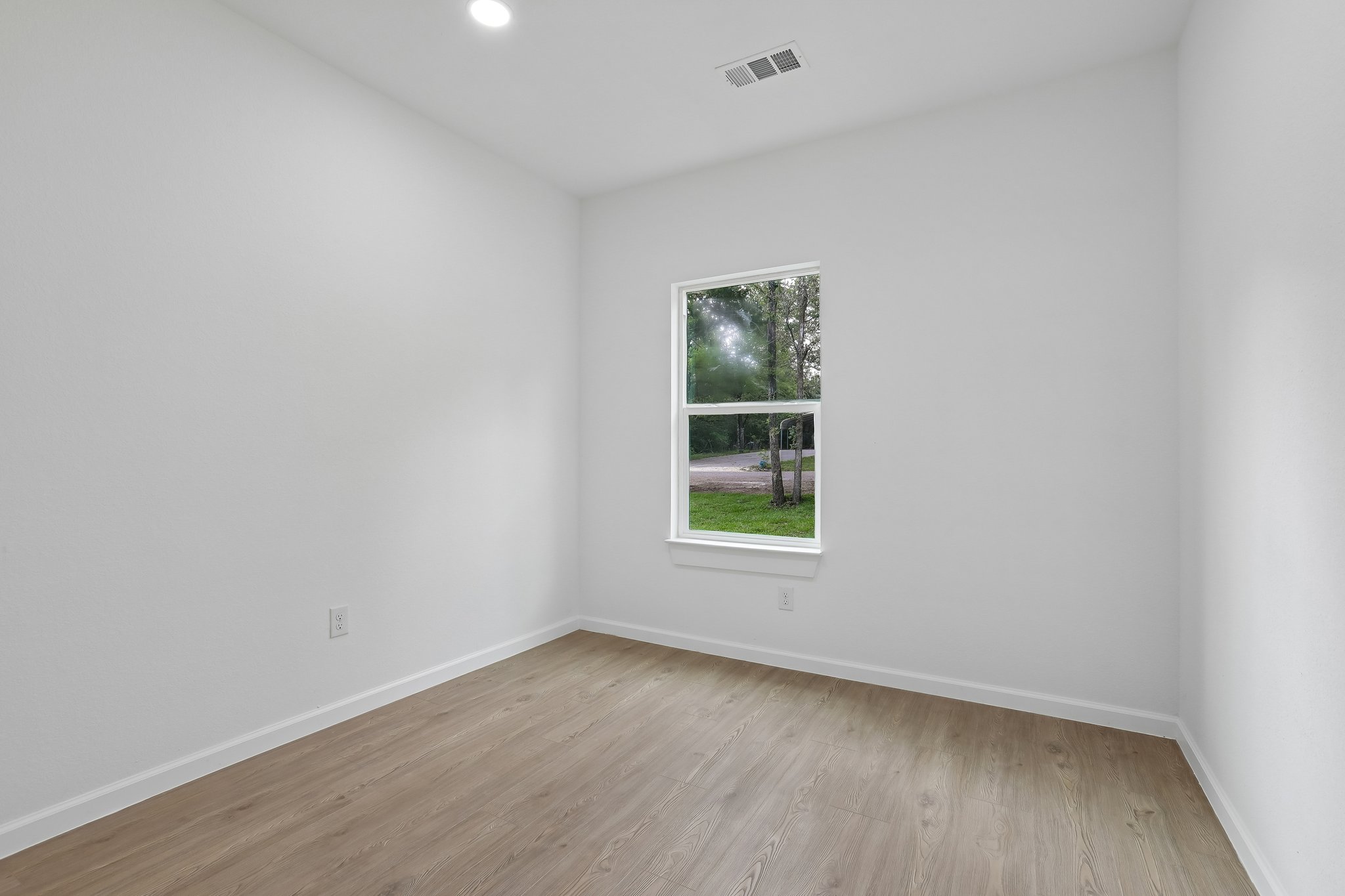 210 Flint Ridge Street Bastrop, TX 78602 - Photo 29 of 40 an empty room with wooden floor and window