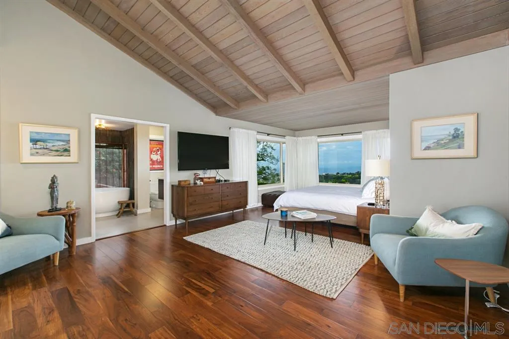1106 Muirlands Drive La Jolla, CA 92037 - Photo 12 of 24 a living room with furniture flat screen tv and wooden floor