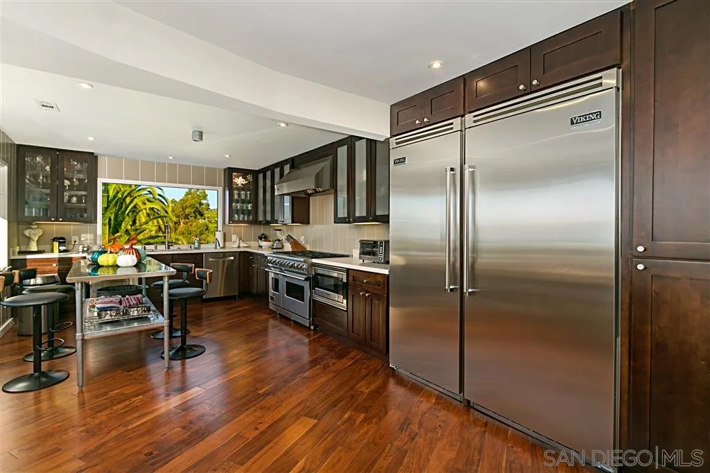 1106 Muirlands Drive La Jolla, CA 92037 - Photo 10 of 24 a kitchen with sink refrigerator and furniture