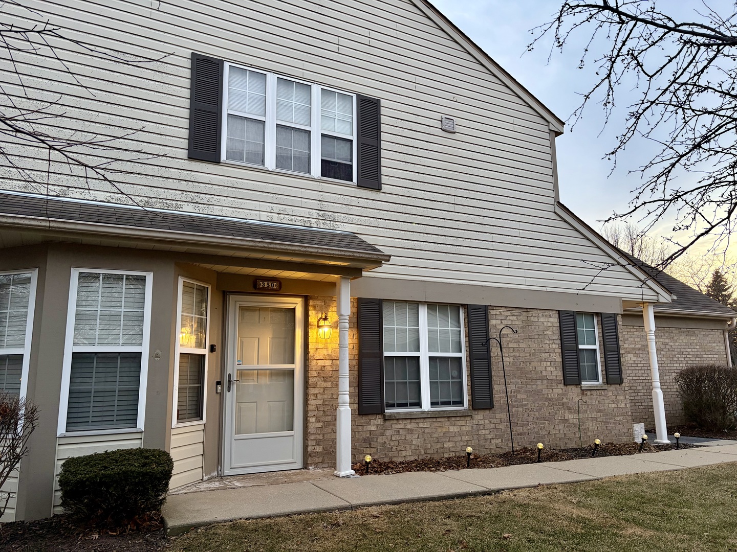 350 Crystal Ridge Drive, Unit 350 Crystal Lake, IL 60012 - Photo 2 of 18 a front view of a house with a yard