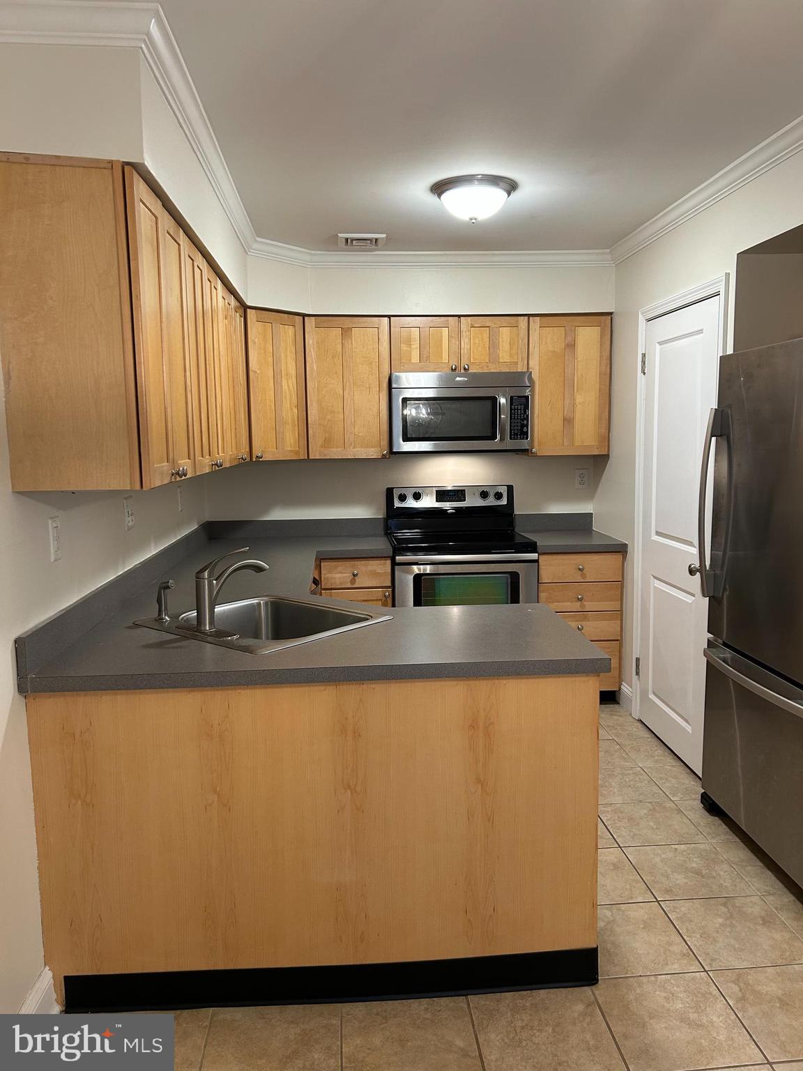 2-3 Aspen Way Doylestown, PA 18901 - Photo 11 of 18 a kitchen with kitchen island a counter top space cabinets stainless steel appliances and a window