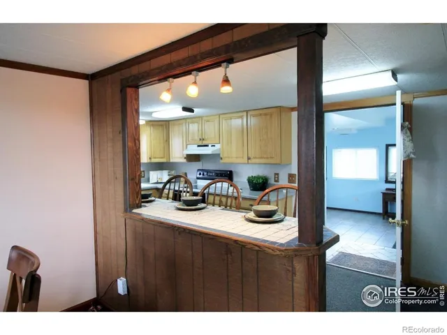 a kitchen with sink and view of living room