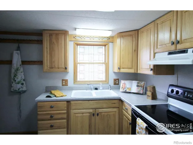 a kitchen with stainless steel appliances sink cabinets and window