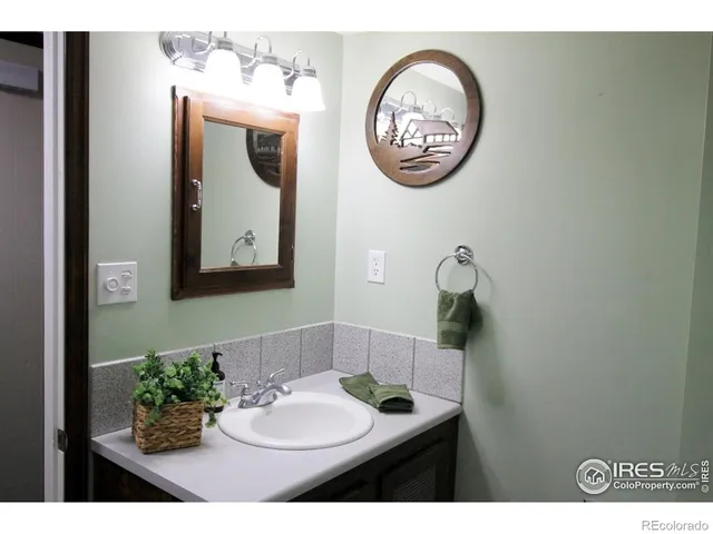 a bathroom with a sink mirror and vanity