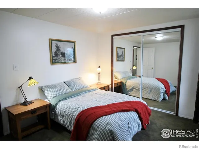 a bedroom with two bed and a lamp