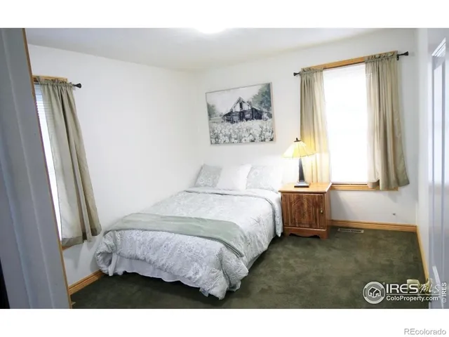 a spacious bedroom with a bed and a window