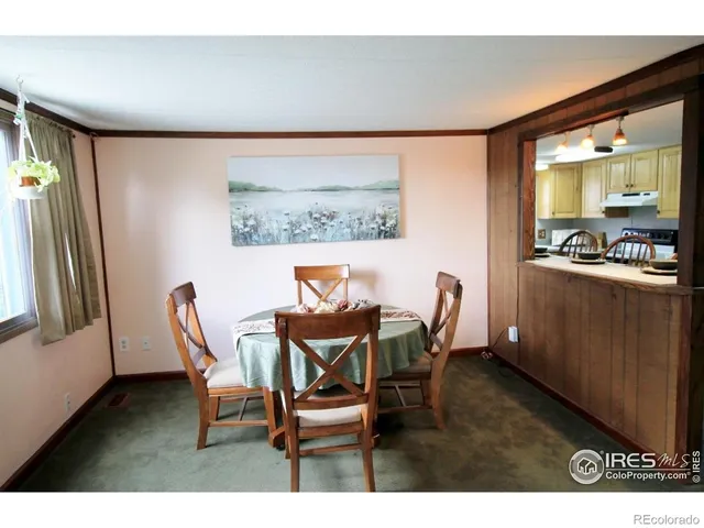 a dining room with furniture and a floor to ceiling window