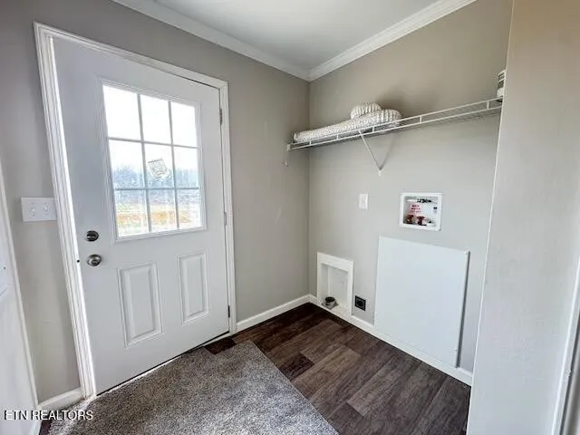 an aerial view of residential houses with yard and trees in the background