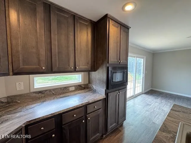 a kitchen with granite countertop wooden cabinets and a granite counter tops