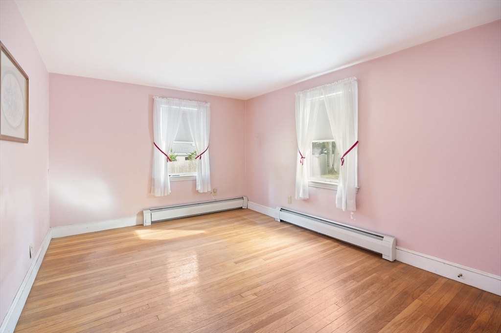110 Linden Street Hamilton, MA 01982 - Photo 14 of 25 an empty room with wooden floor and windows