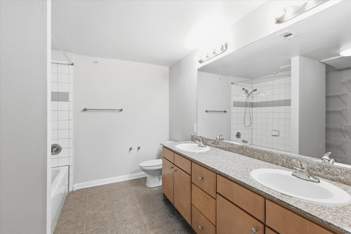 2502 Leon Street, Unit 414 Austin, TX 78705 - Photo 12 of 21 a spacious bathroom with a granite countertop sink toilet and shower