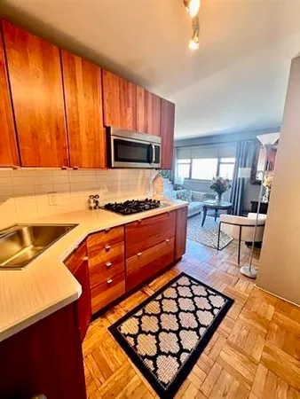 a kitchen with a stove a sink and a microwave