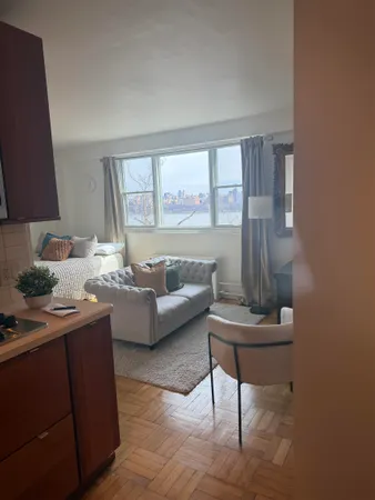 a living room with furniture and a large window