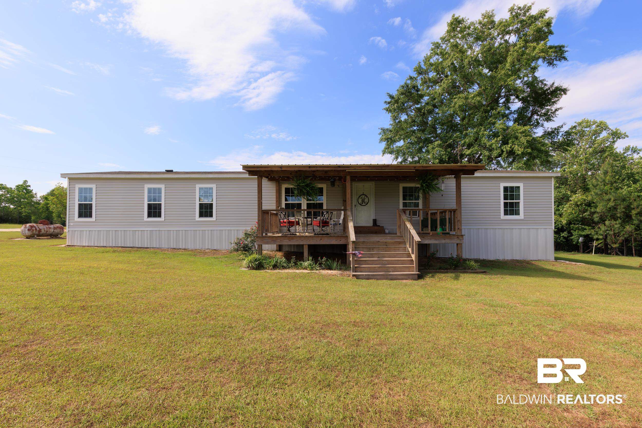 6725 Upper Creek Road Flomaton, AL 36441 - Photo 1 of 61 Rear view of house with covered porch and a lawn