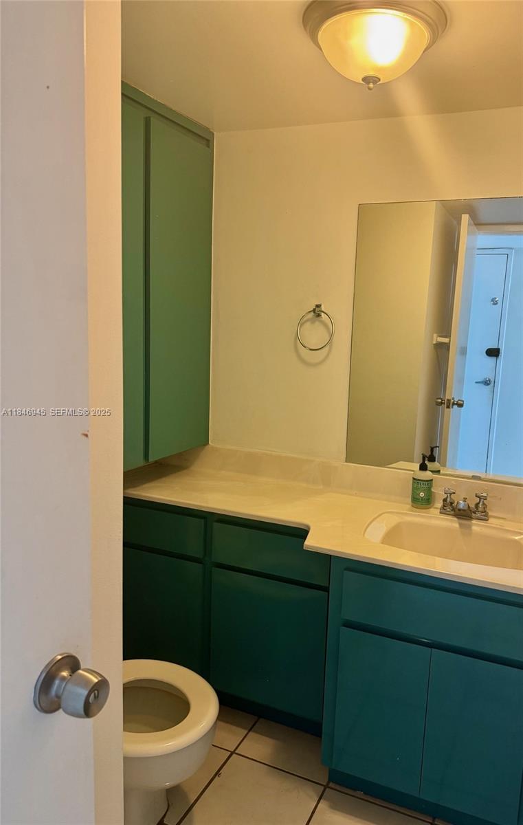 1228 West Avenue, Unit 1109 Miami Beach, FL 33139 - Photo 4 of 10 a bathroom with a sink and a mirror