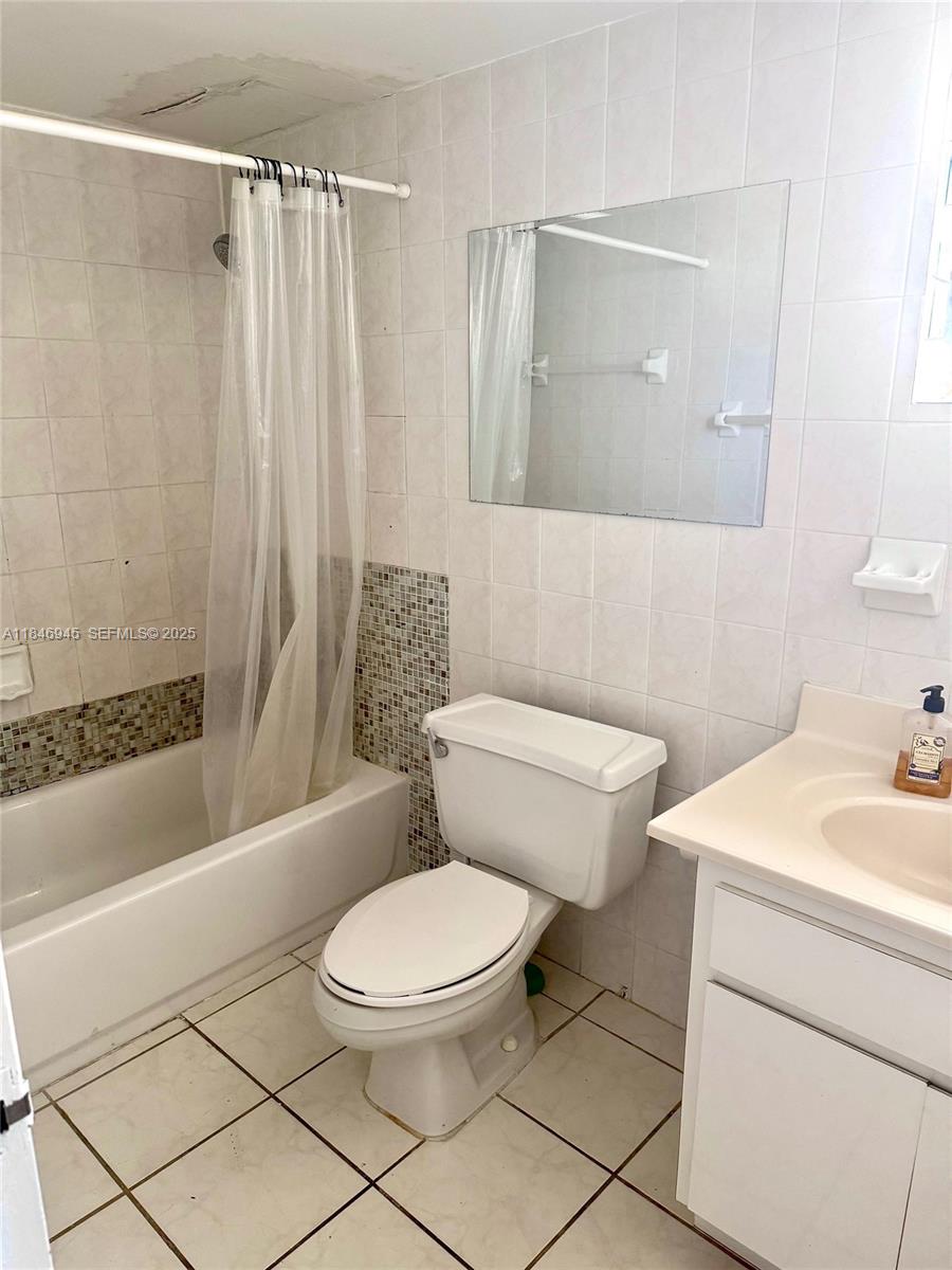 1228 West Avenue, Unit 1109 Miami Beach, FL 33139 - Photo 5 of 10 a white toilet sitting next to a bath tub