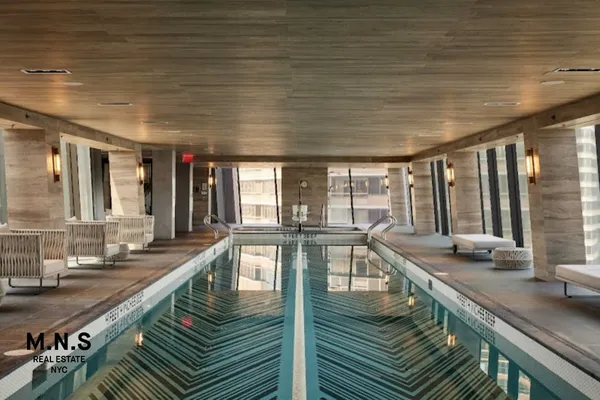 a view of a swimming pool with outdoor seating