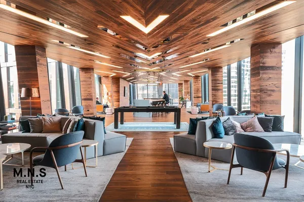 a living room with furniture wooden floor and a table