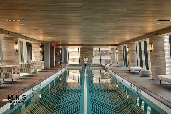 a view of a swimming pool with outdoor seating