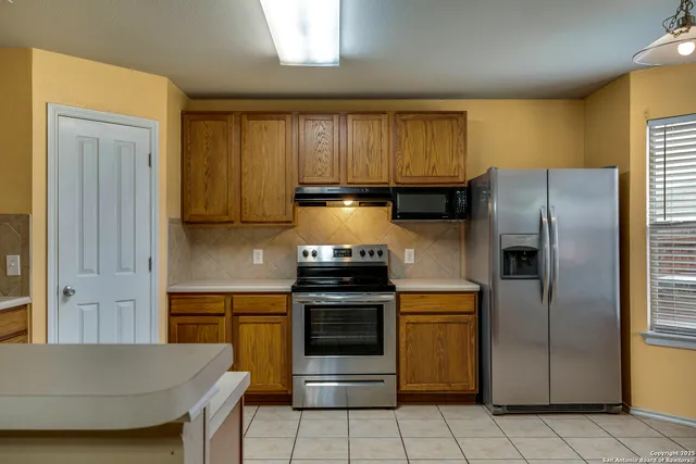 a kitchen with a stove and a refrigerator