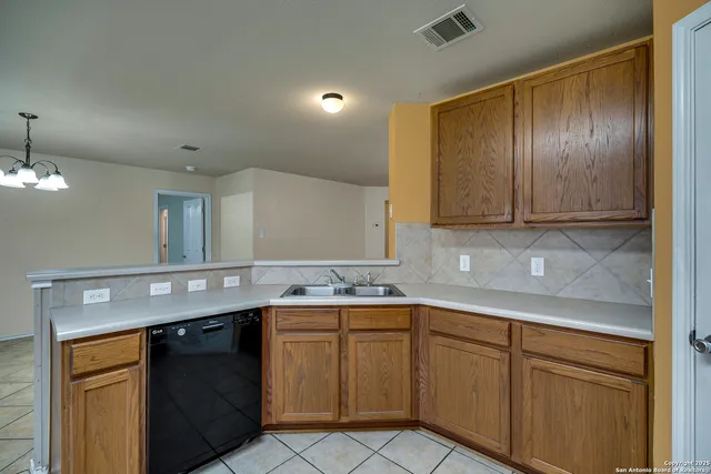 a kitchen with a sink and cabinets
