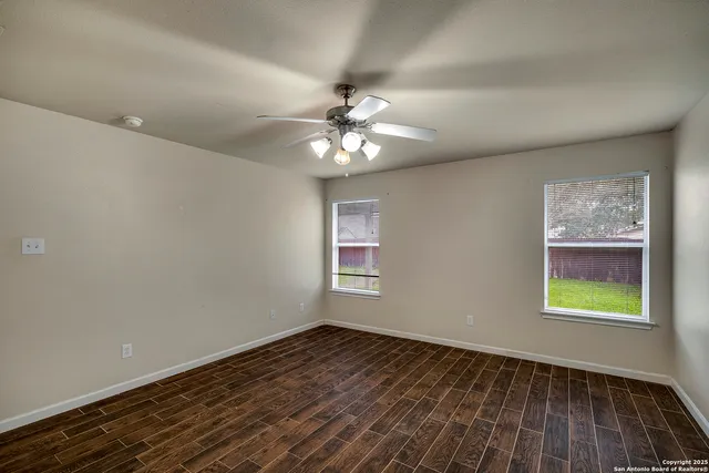wooden floor in an empty room with a window