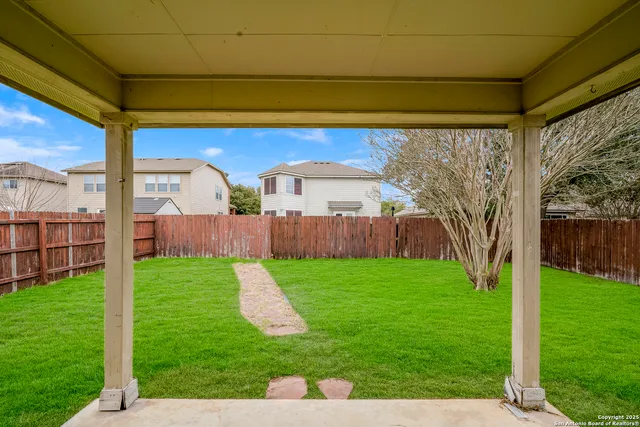 a view of a backyard with large trees