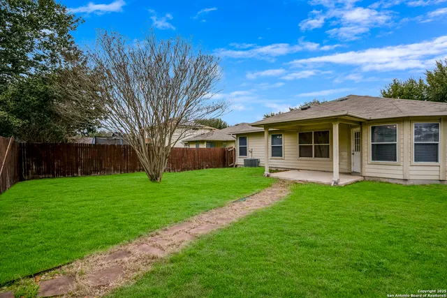 a view of a yard with a house in the background