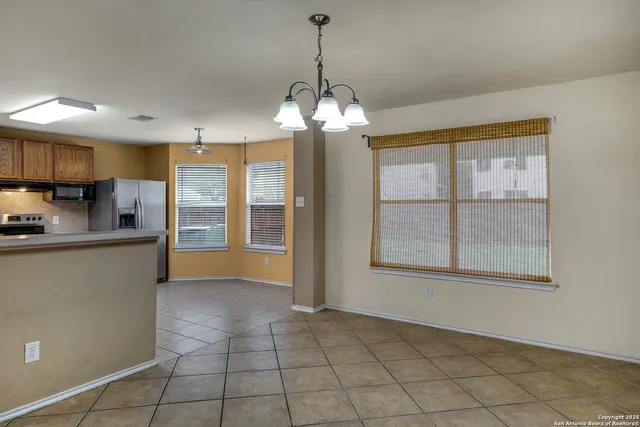 a view of kitchen with windows and refrigerator