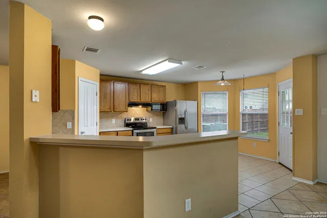 a kitchen with stainless steel appliances a sink and a large window