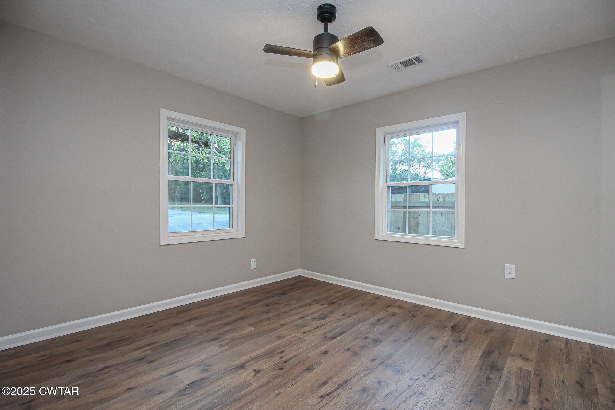 107 Lower Brownsville Road Jackson, TN 38301 - Photo 13 of 17 wooden floor in an empty room with a window