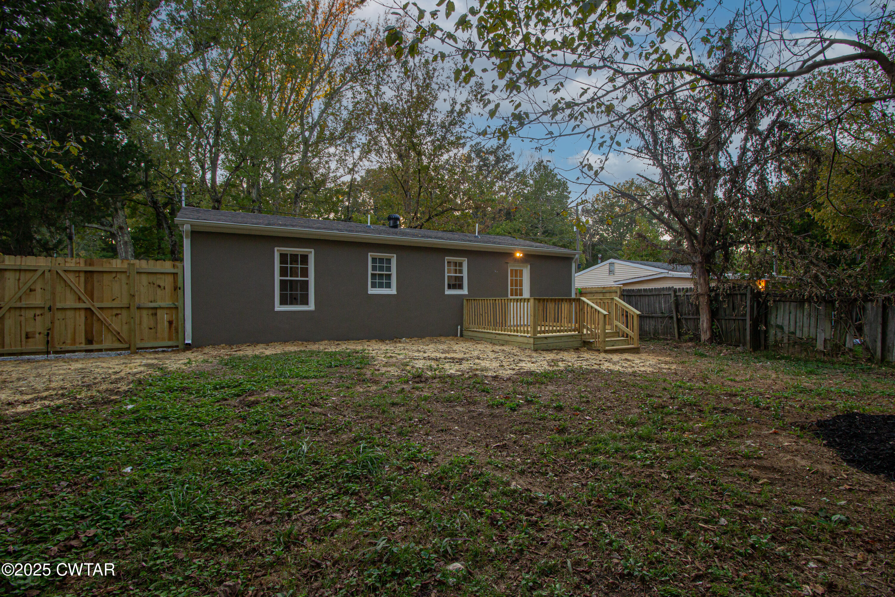 107 Lower Brownsville Road Jackson, TN 38301 - Photo 16 of 17 a view of a backyard with a garden and tree