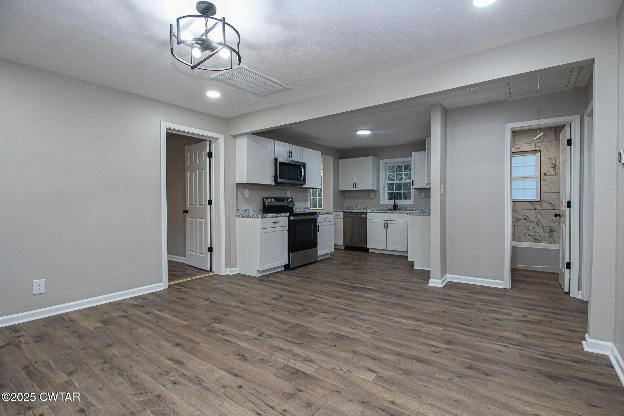 107 Lower Brownsville Road Jackson, TN 38301 - Photo 4 of 17 a view of kitchen with refrigerator microwave and cabinets