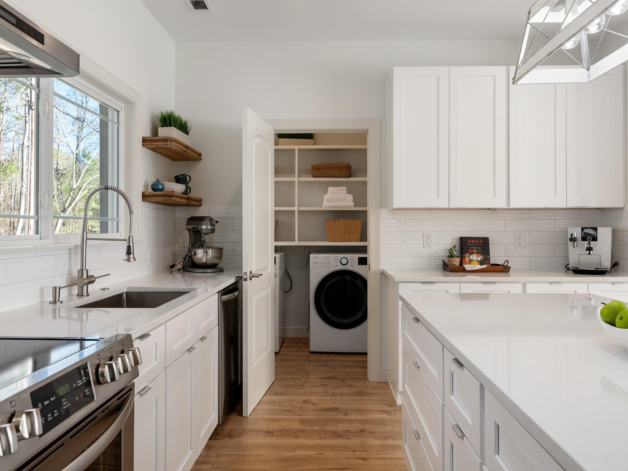 7417 New Town Road Waxhaw, NC 28173 - Photo 11 of 41 a kitchen with a sink a stove and cabinets