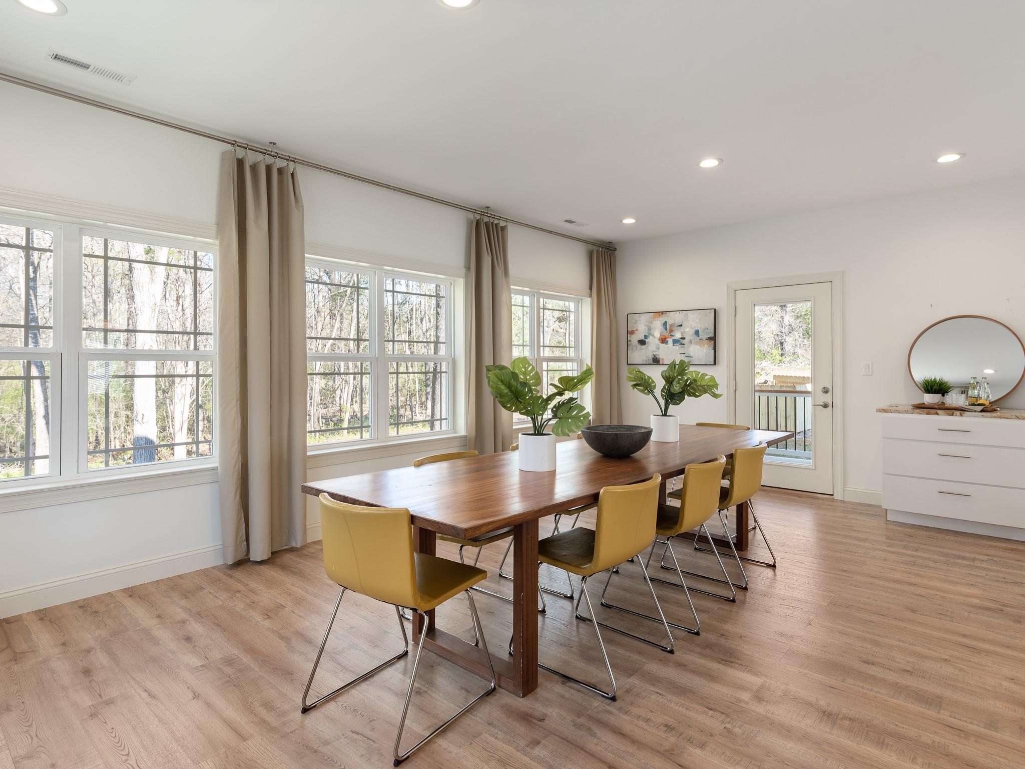 7417 New Town Road Waxhaw, NC 28173 - Photo 18 of 41 a view of a dining room with furniture and wooden floor