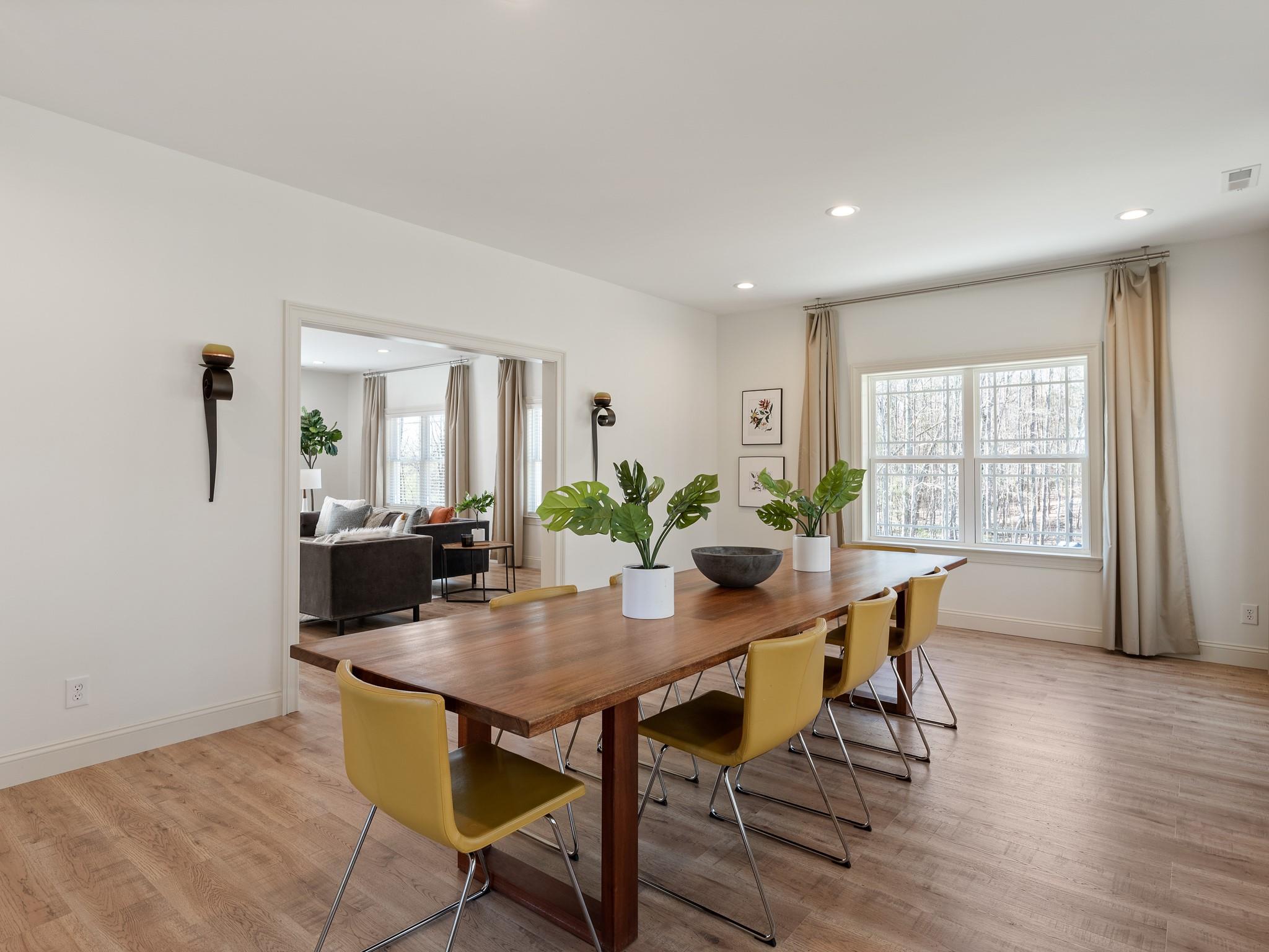 7417 New Town Road Waxhaw, NC 28173 - Photo 19 of 41 a view of a dining room with furniture and wooden floor