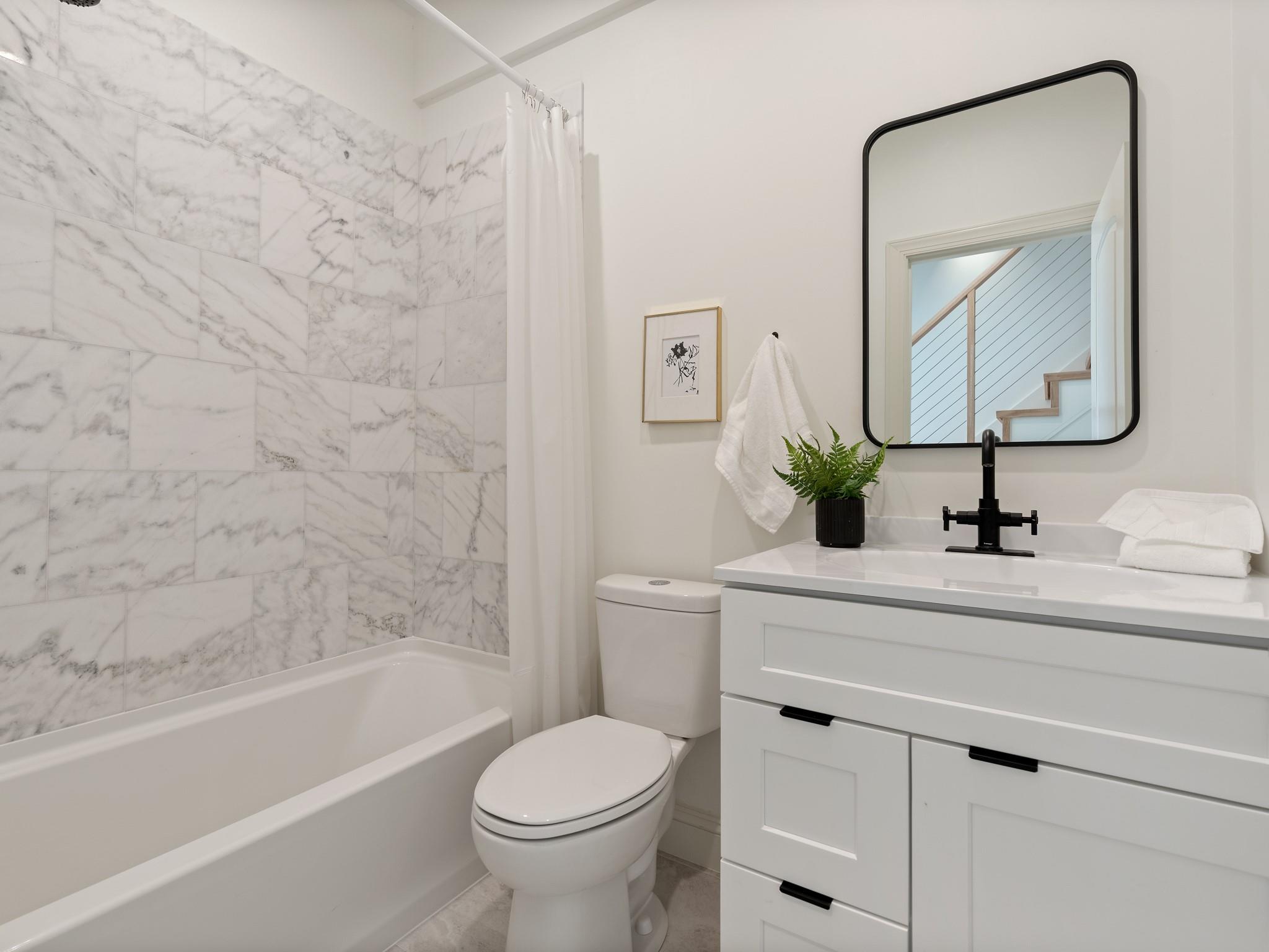 7417 New Town Road Waxhaw, NC 28173 - Photo 21 of 41 a bathroom with a sink a toilet and a bathtub