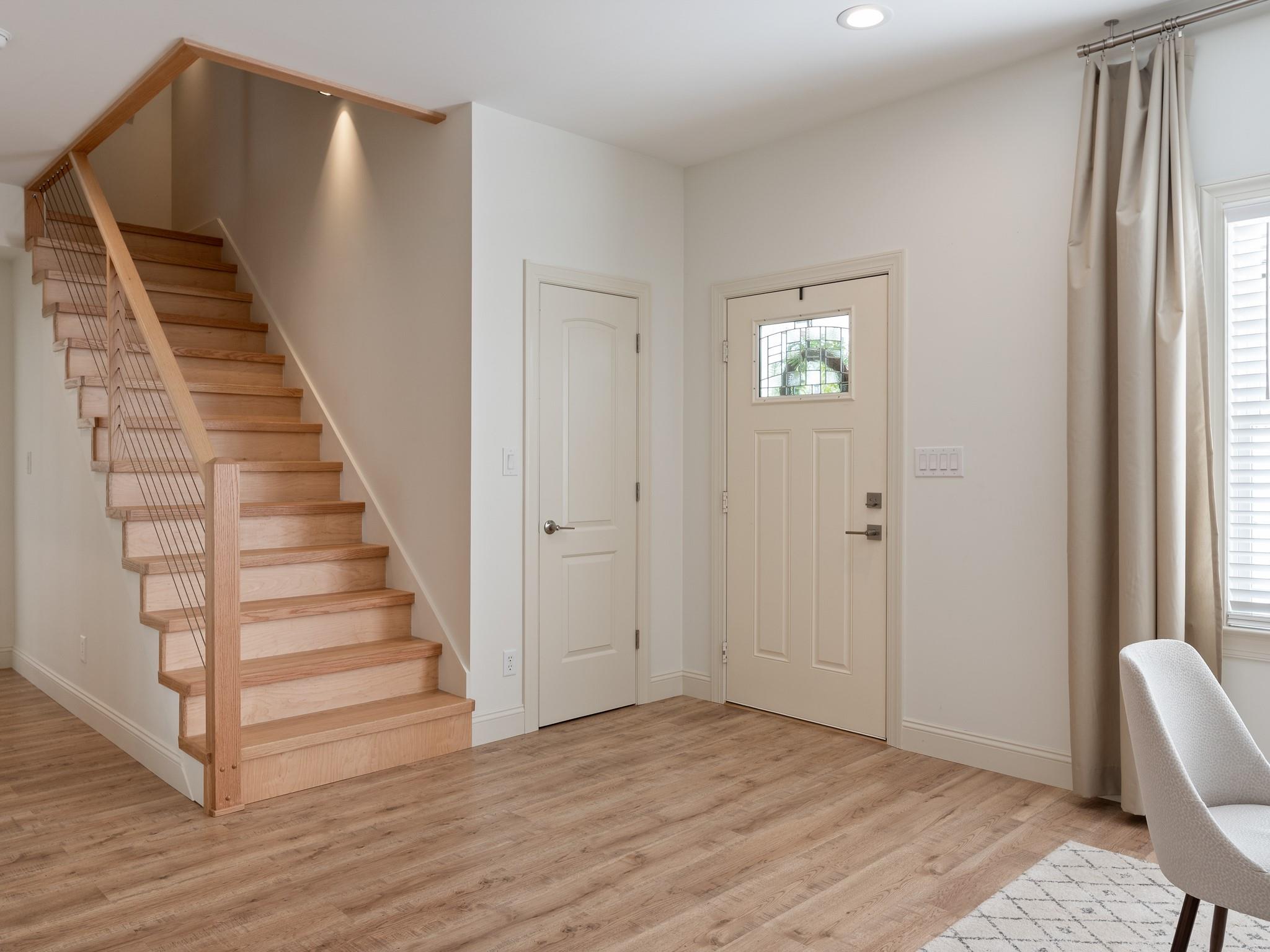 7417 New Town Road Waxhaw, NC 28173 - Photo 7 of 41 a view of a hallway with entryway wooden floor and front door