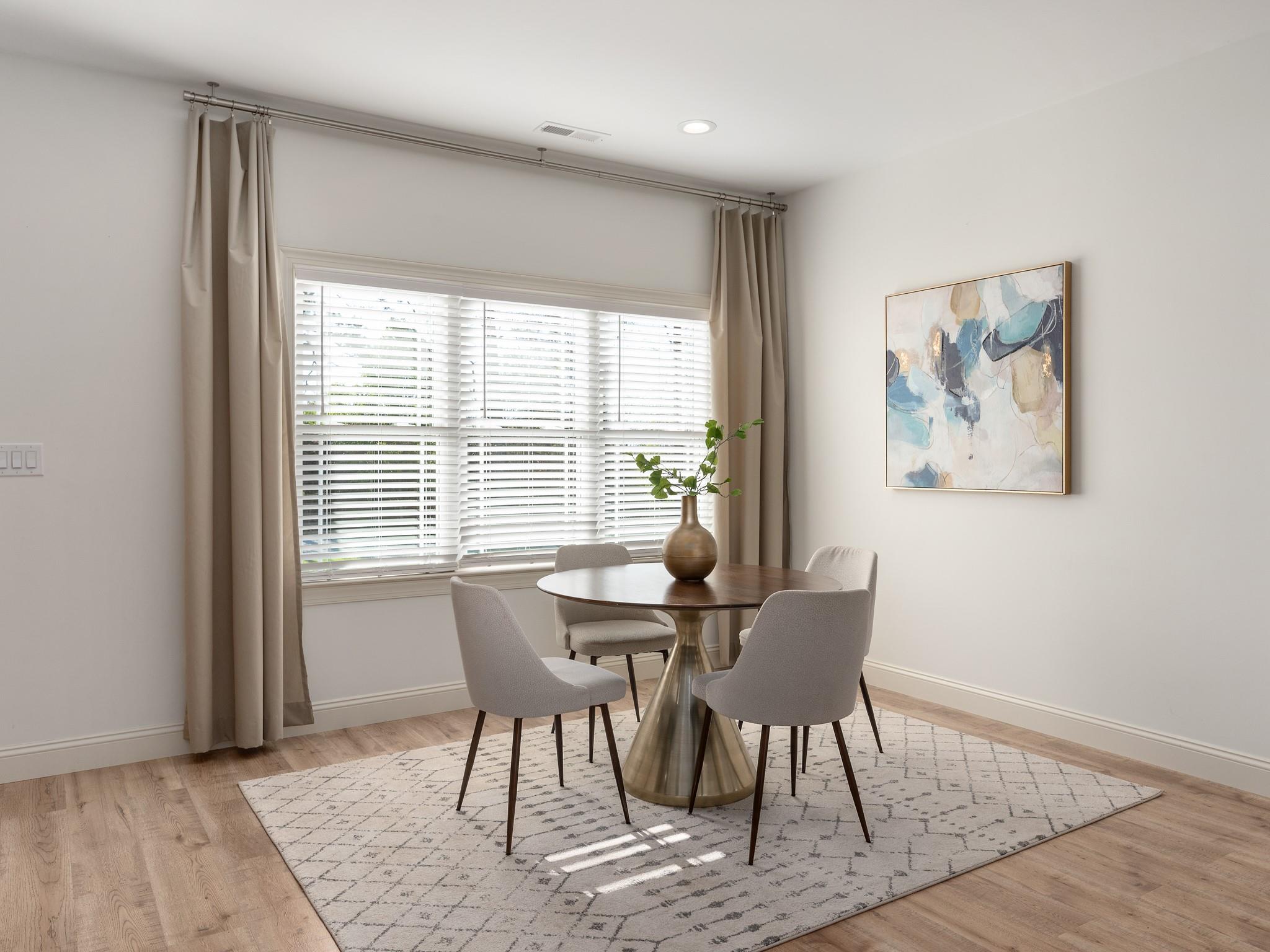 7417 New Town Road Waxhaw, NC 28173 - Photo 8 of 41 a view of a dining room with furniture window and wooden floor