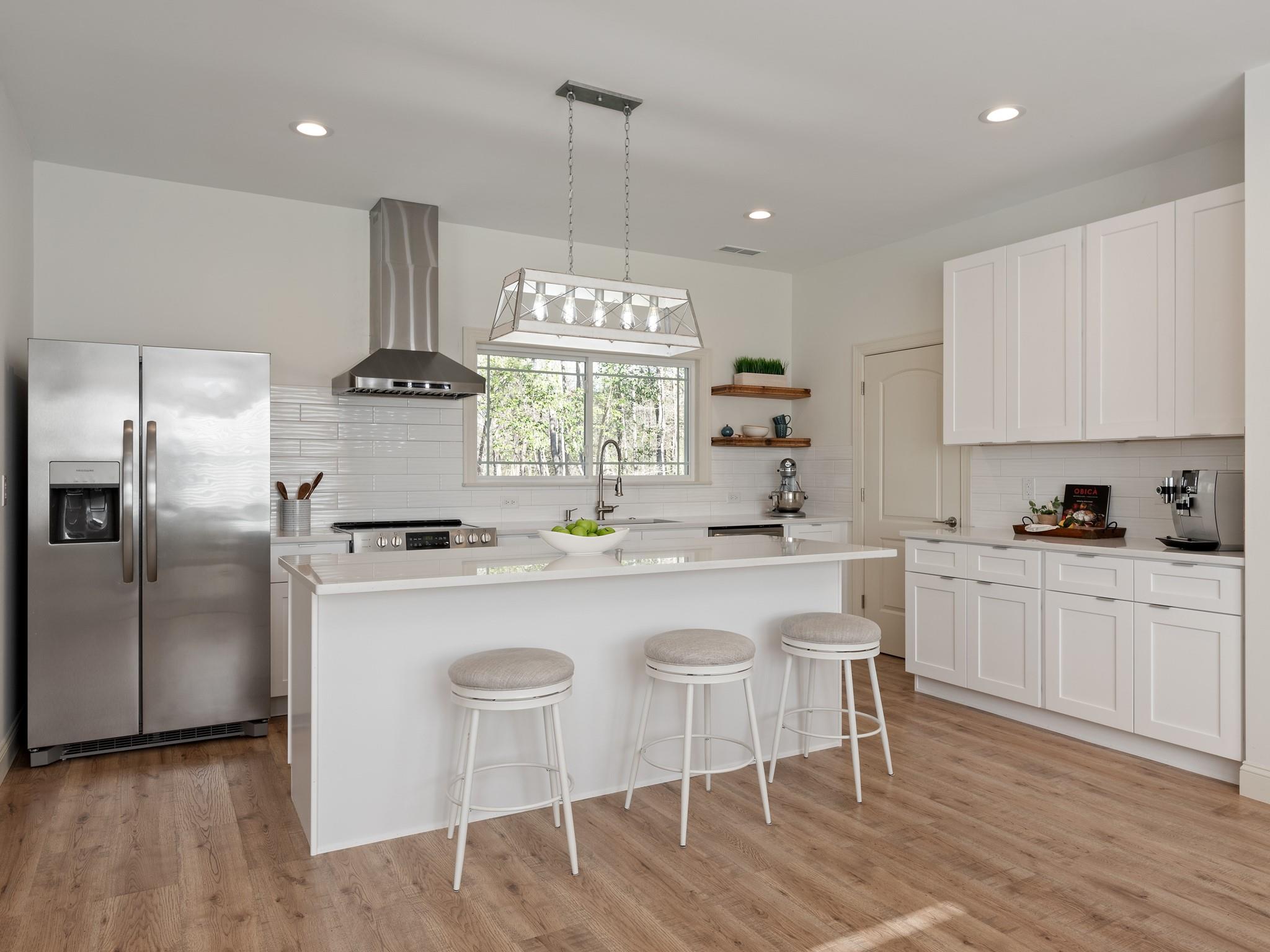 7417 New Town Road Waxhaw, NC 28173 - Photo 9 of 41 a kitchen with stainless steel appliances granite countertop a sink a stove a refrigerator cabinets and chairs
