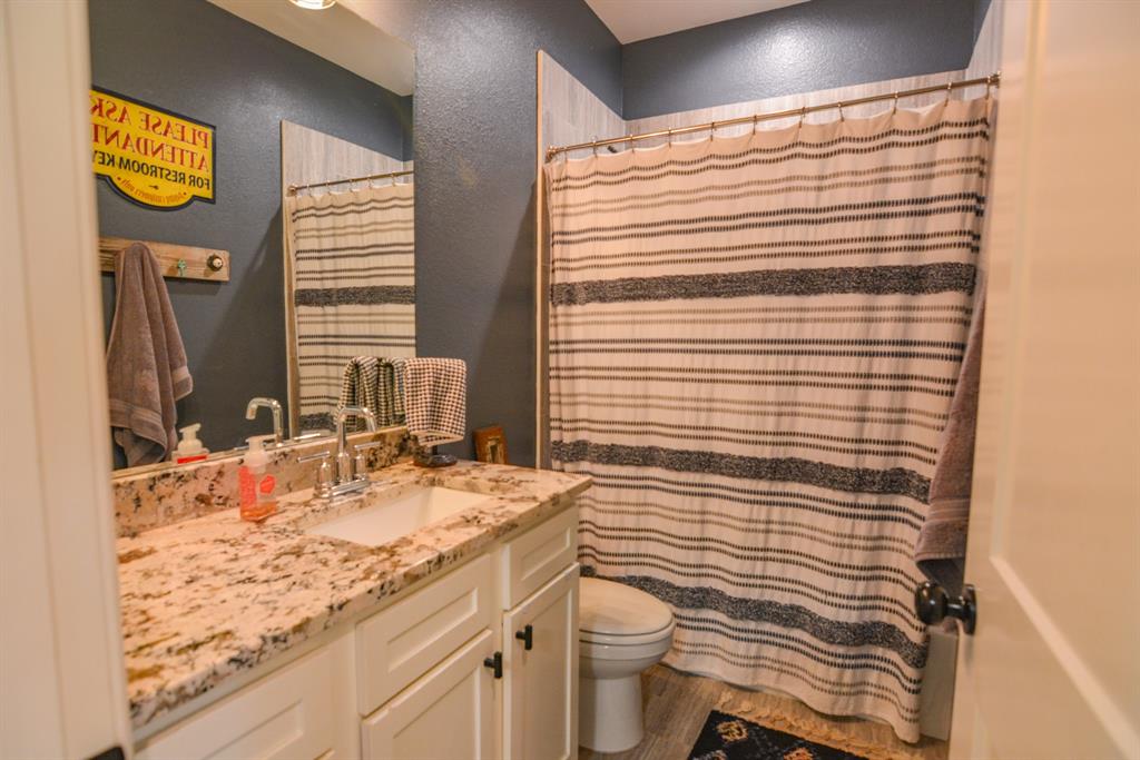 601 Mathew Street Grandview, TX 76050 - Photo 27 of 40 a bathroom with a sink a toilet and mirror