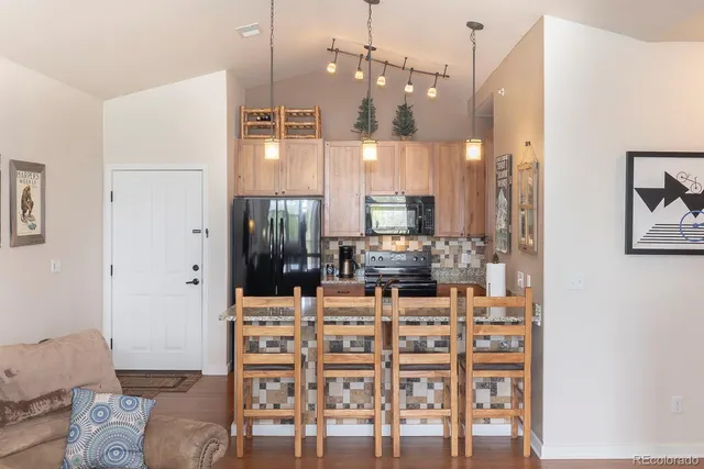 a kitchen with a refrigerator and microwave