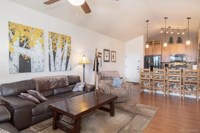 a living room with furniture and wooden floor