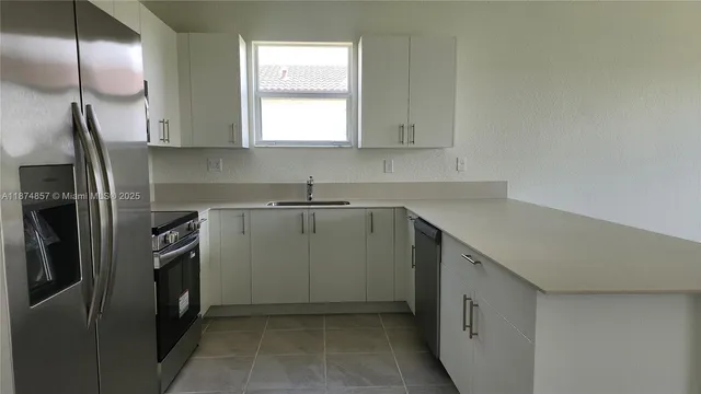 a kitchen with a sink microwave and refrigerator