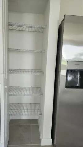 a view of staircase with white walls and a window